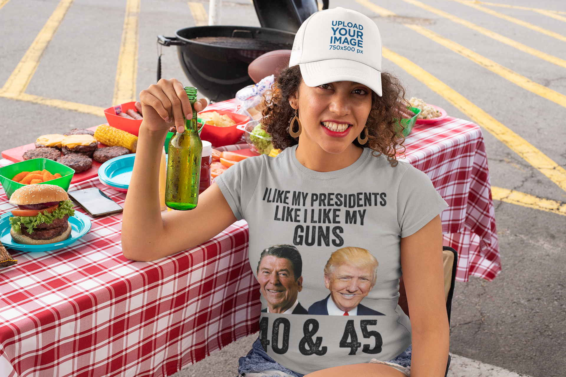 Woman holding a drink, wearing a t-shirt saying I Like My Presidents Like I Like My Guns 40 & 45 at a barbecue.