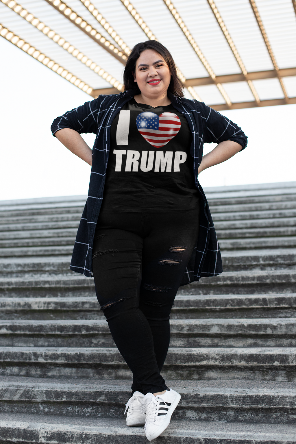 Person wearing I Heart USA Flag Trump Classic Supporter Graphic Tee on outdoor steps.