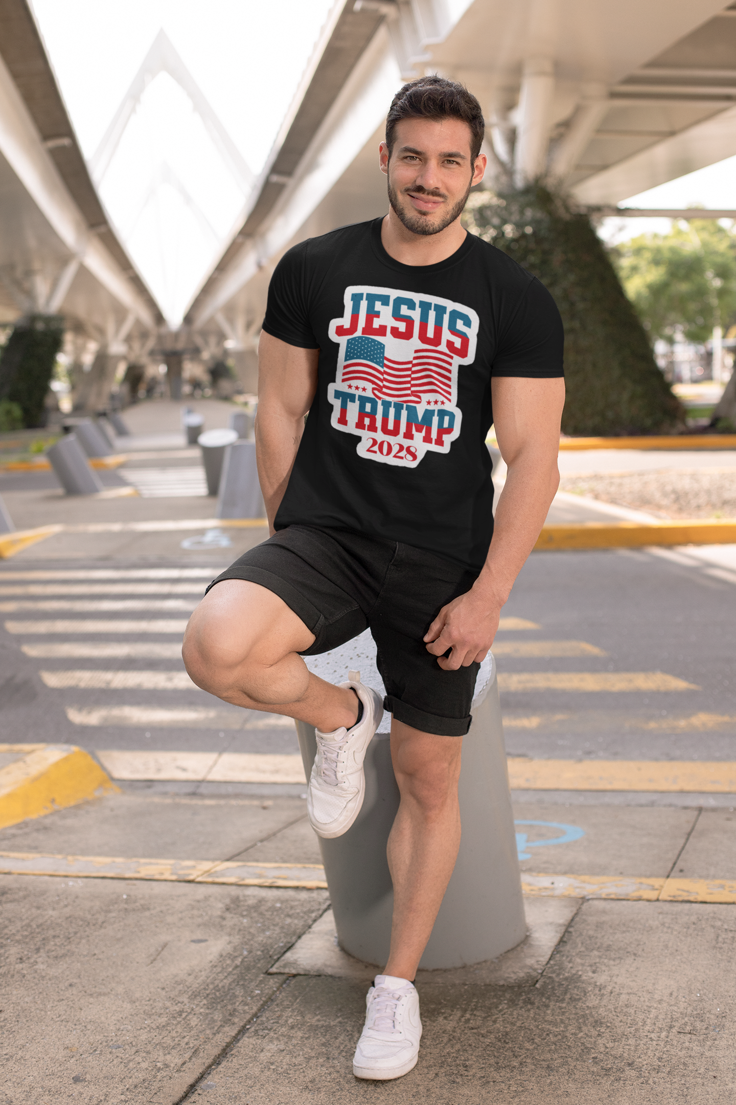 Man wearing Jesus Trump 2028 USA Patriotic Style black t-shirt while posing outdoors.