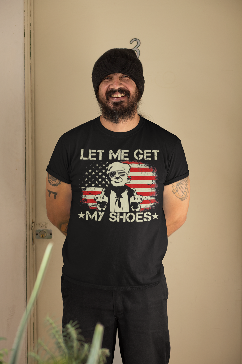 Person wearing a Let Me Get My Shoes Statement Shirt with an American flag design, smiling and showcasing the shirt.