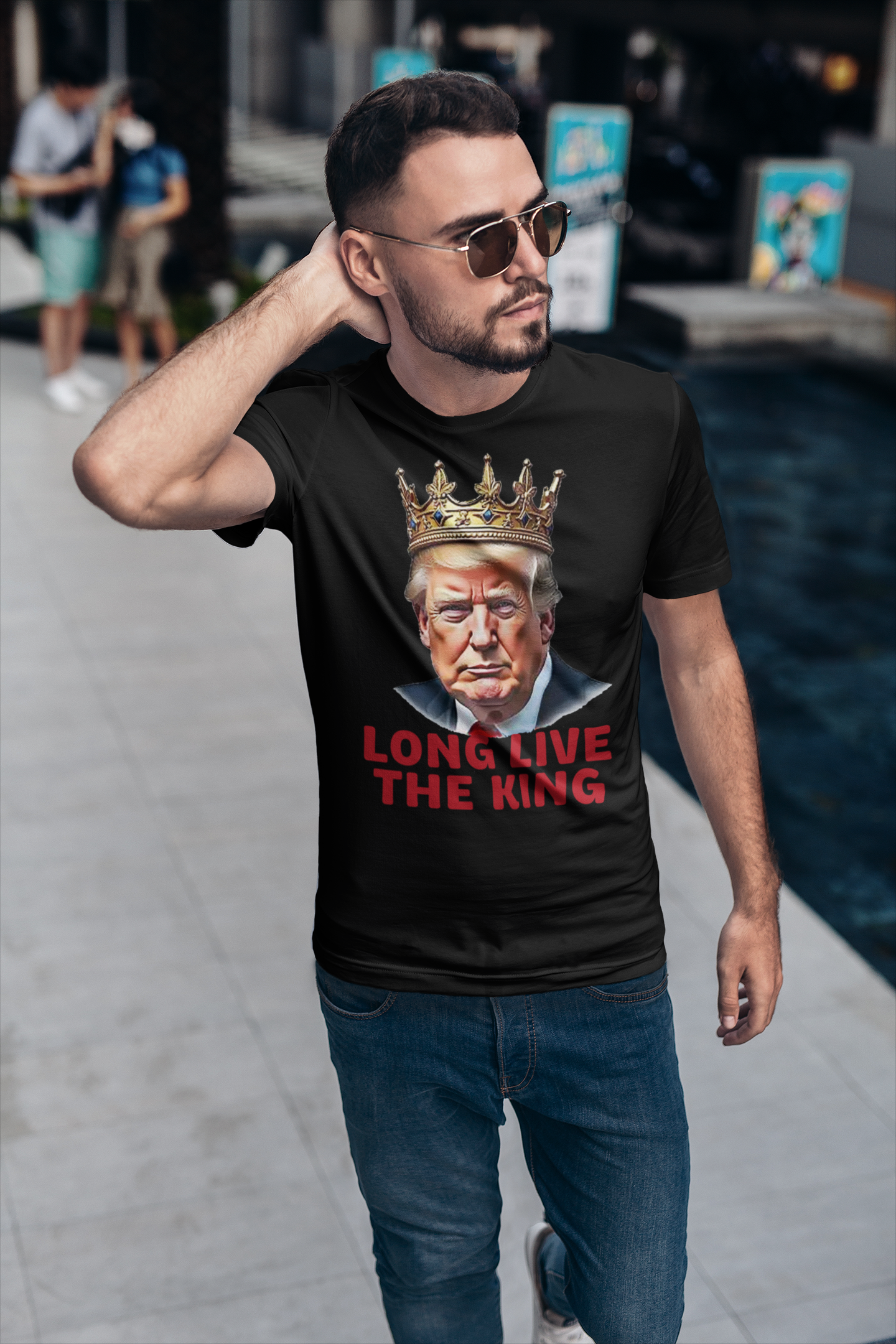Man wearing Long Live the King Vintage Shirt with a crown graphic and bold text while walking outdoors.