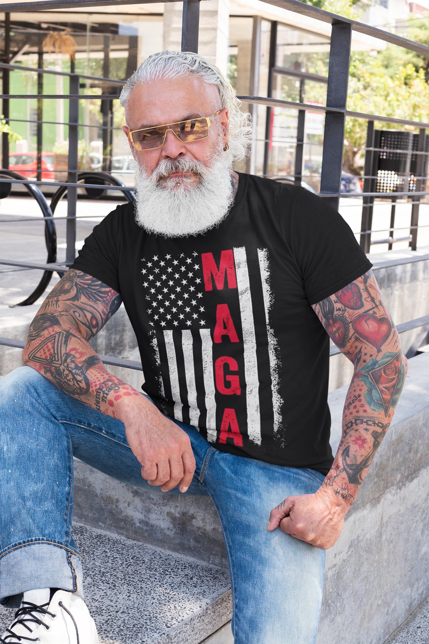 MAGA B W American Flag Apparel worn by man with beard and tattoos, showcasing patriotic style in urban setting.