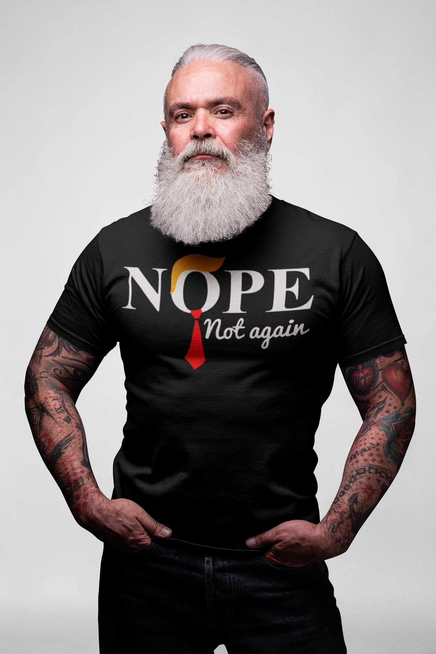 Man with a beard wearing Nope Not Again Trump Hair & Tie graphic tee, expressing political conviction.