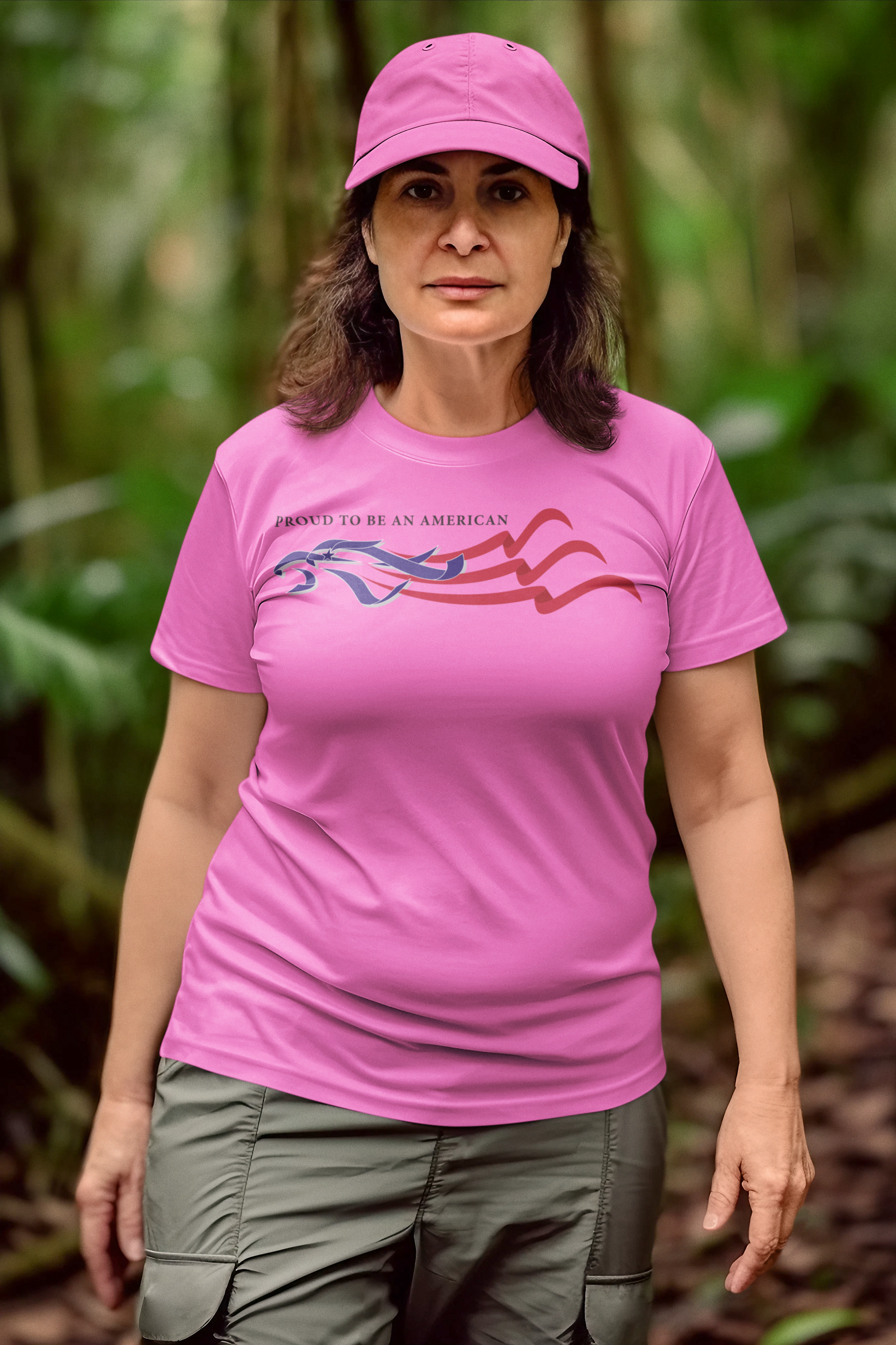 Woman wearing a Proud To Be An American Eagle Flag shirt in a forest setting.