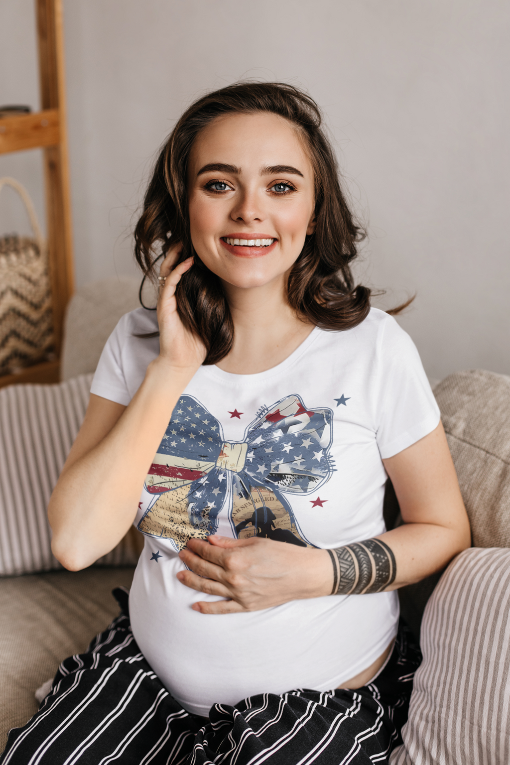 Ribbon As American Flag With Saluting Soldier shirt worn by smiling pregnant woman sitting on a couch.