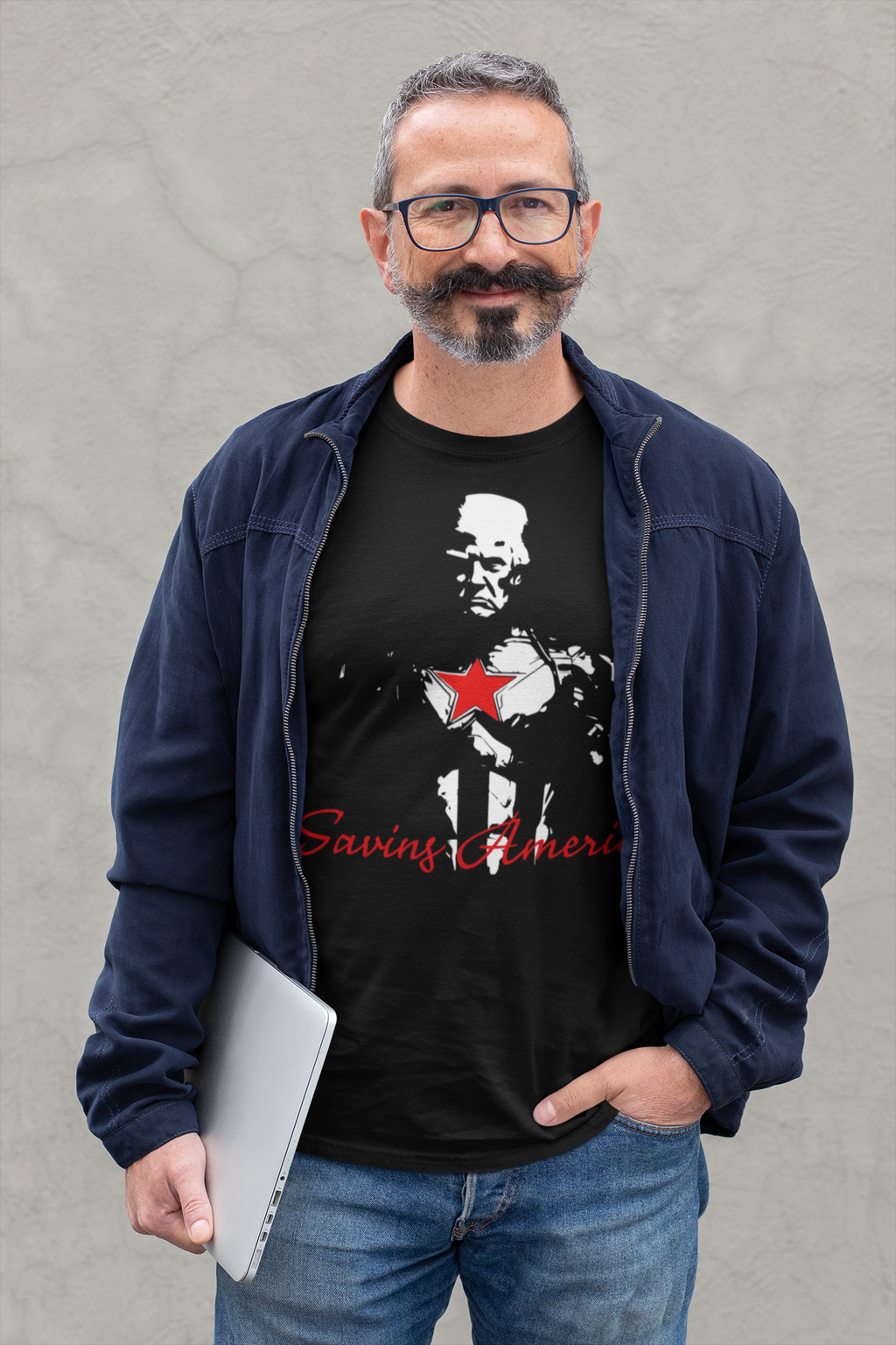 Man wearing a Saving America Graphic Design Tee with a patriotic graphic design and a laptop.
