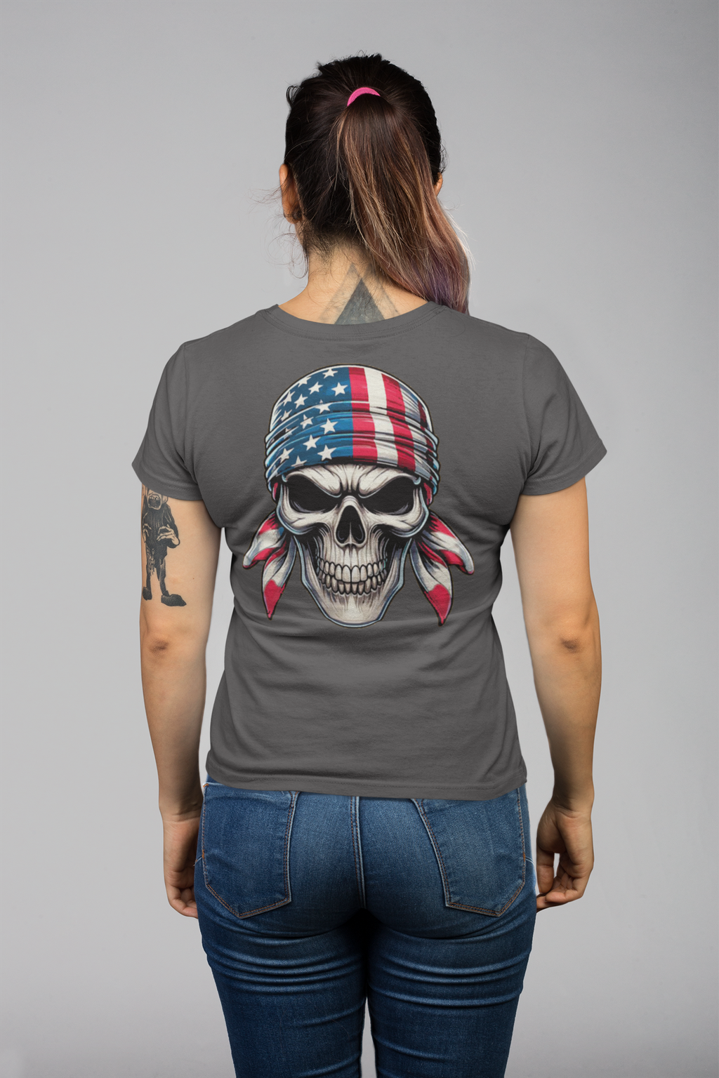 Woman wearing Skull Wrapped In American Flag Graphic Shirt with large skull design on back.