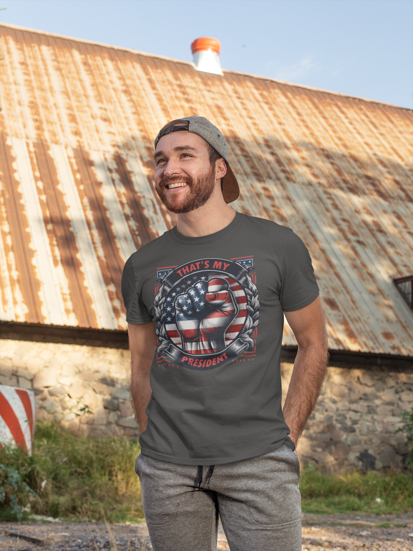 Man wearing a shirt featuring the design 'That's My President Fist In Stars And Stripes' outdoors.
