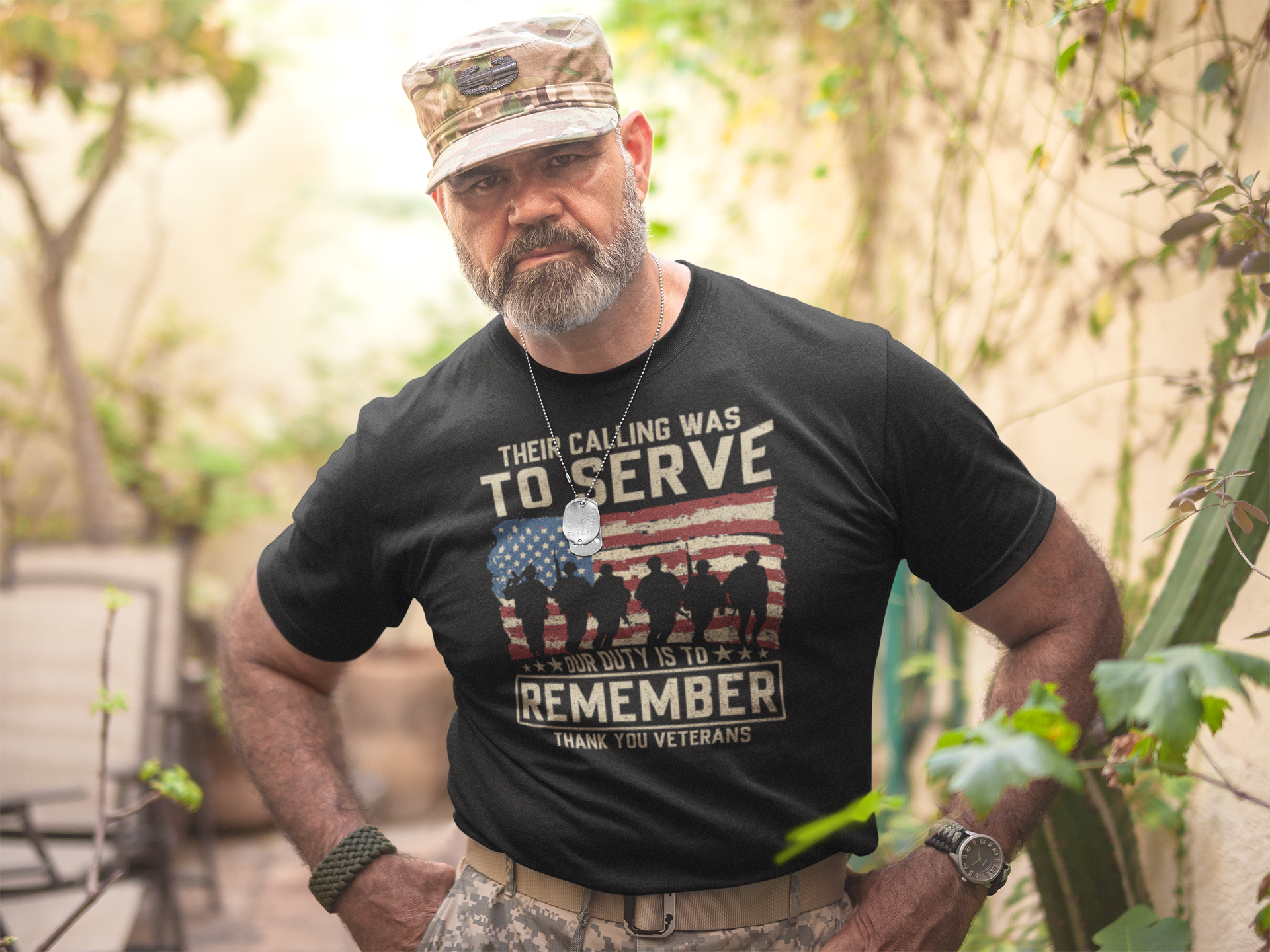 Their Calling Was To Serve Our Duty Is To Remember merchandise worn by a veteran in a garden setting.