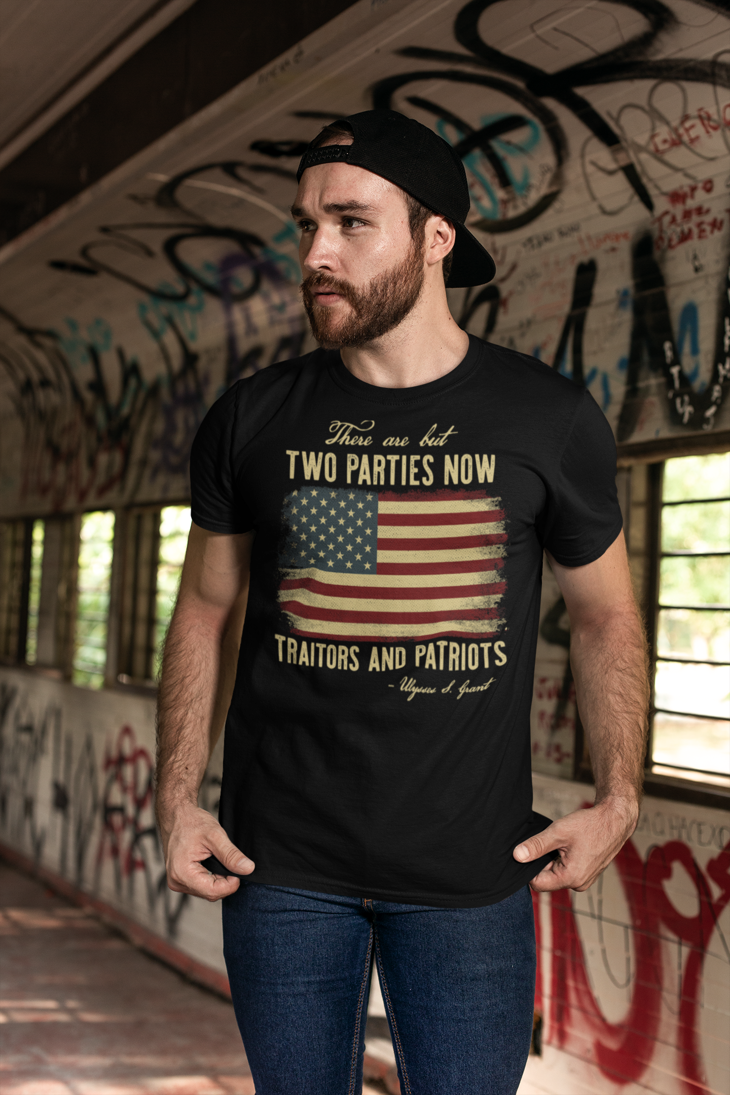 A man wearing a graphic t-shirt that says 'There Are But Two Parties Now Traitors And Patriots' with an American flag design.