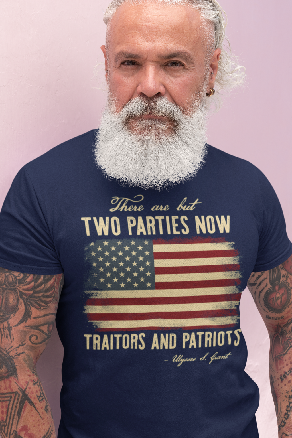 There Are But Two Parties Now Traitors And Patriots graphic t-shirt worn by a bearded man with a patriotic design.