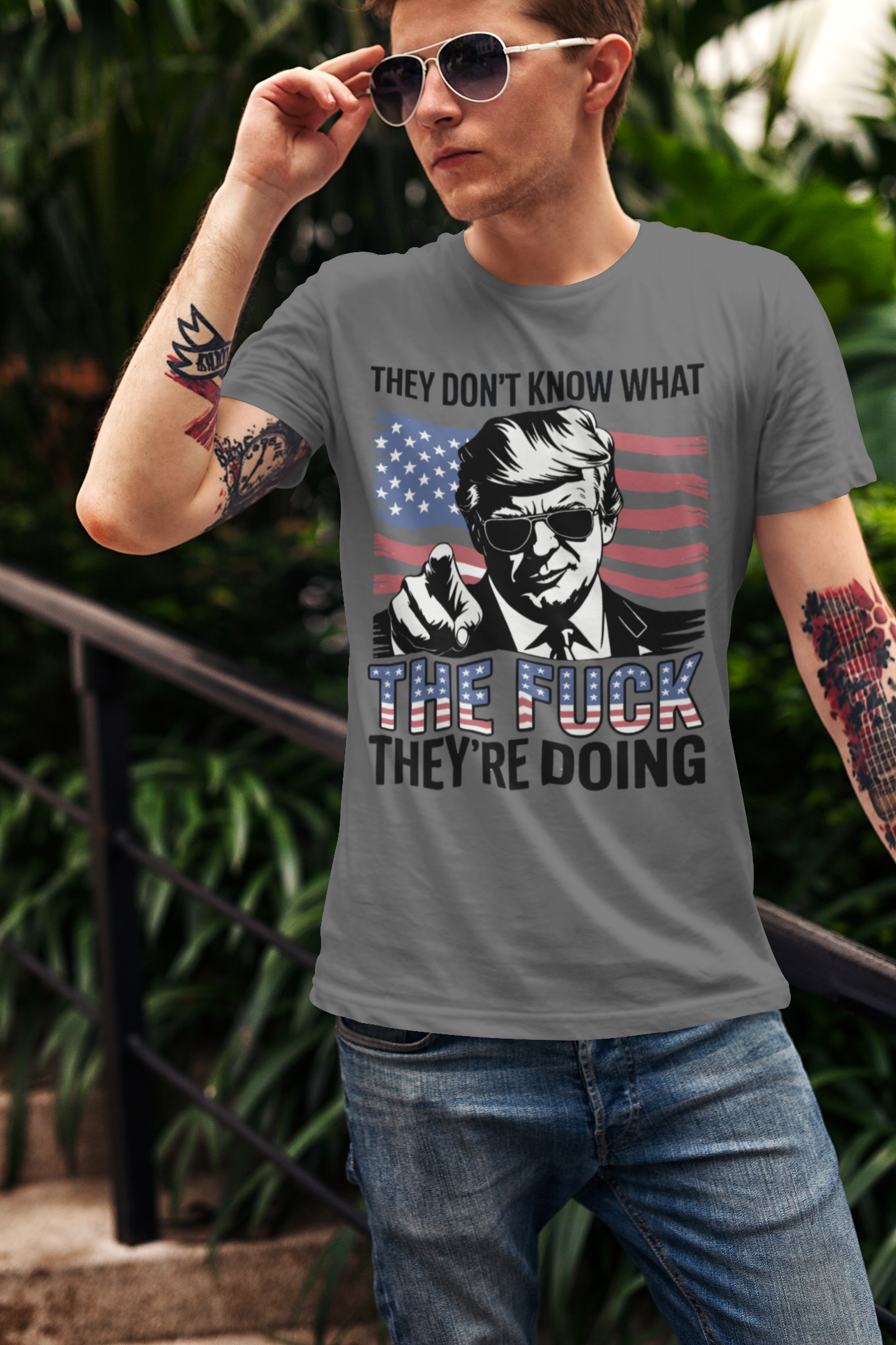 Man wearing a shirt featuring the quote 'They Don't Know What The Fuck They're Doing' with an American flag design.