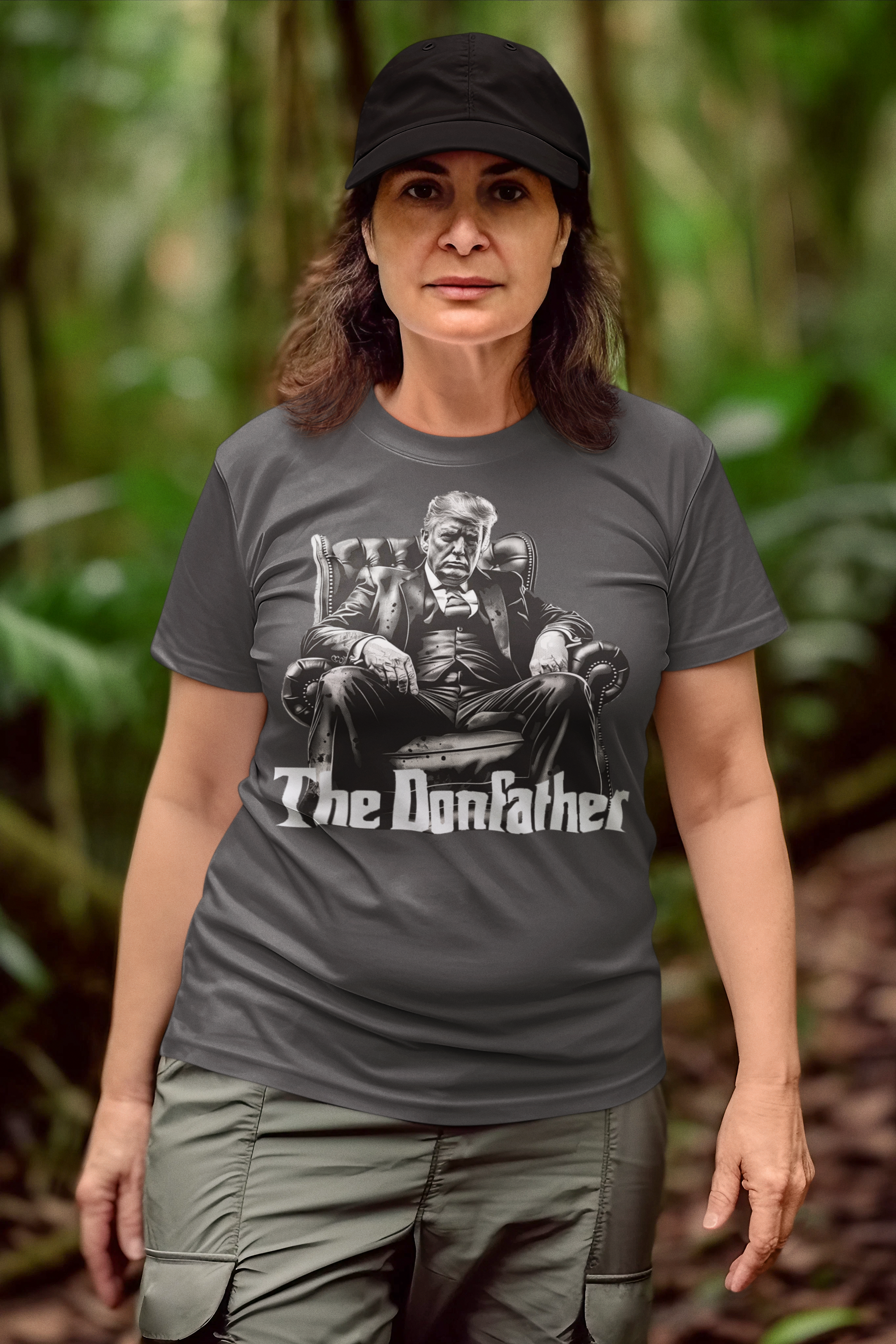 Woman wearing The Donfather Seated Vintage Design t-shirt in a lush green forest.