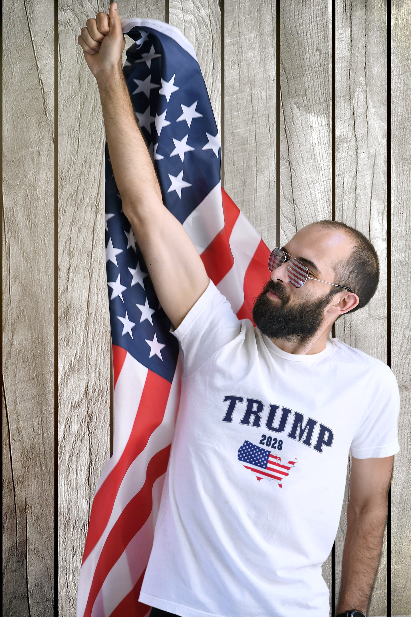 Man wearing Trump 2028 t-shirt, holding USA flag, representing Trump USA Flag Portrait Graphic.