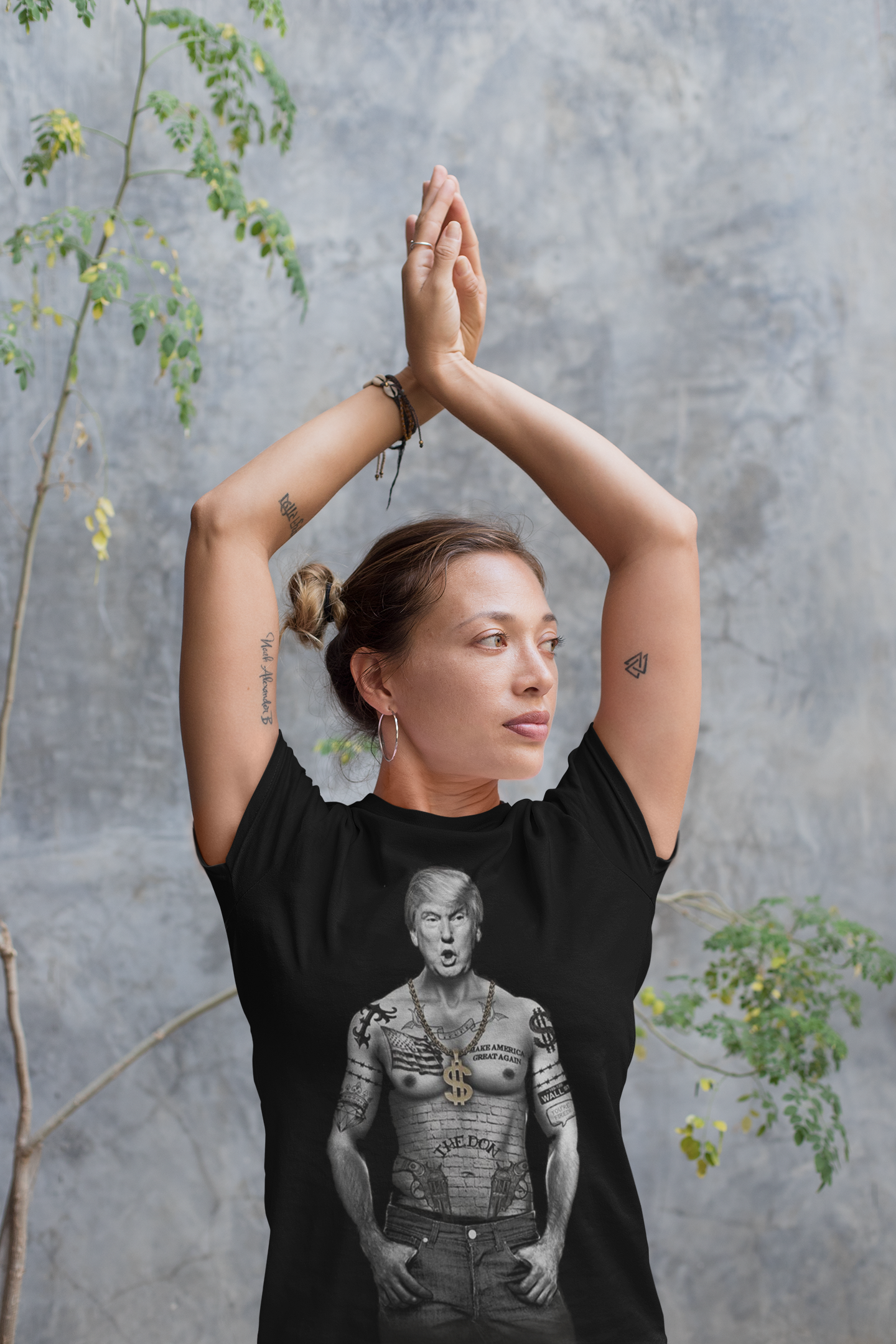 Woman wearing graphic t-shirt with President Trump Power Pose Art Design, featuring expressive Trump art in outdoor setting.