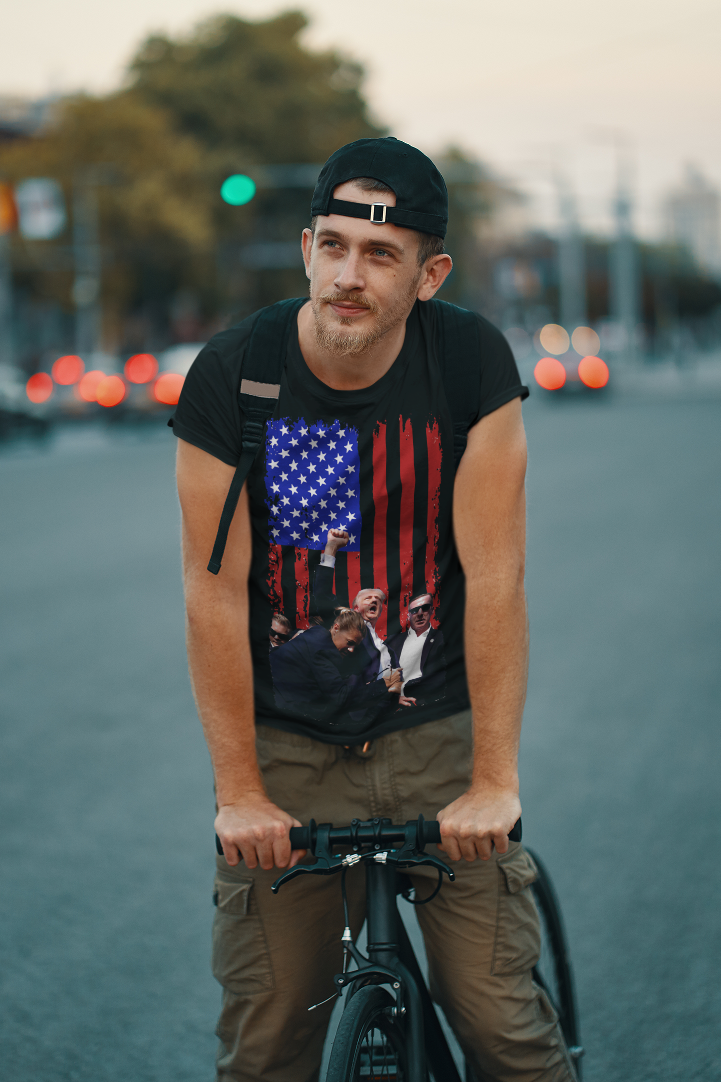 Man in bike wearing Trump Shot American Flag Design t-shirt, symbolizing patriotism and personal values.
