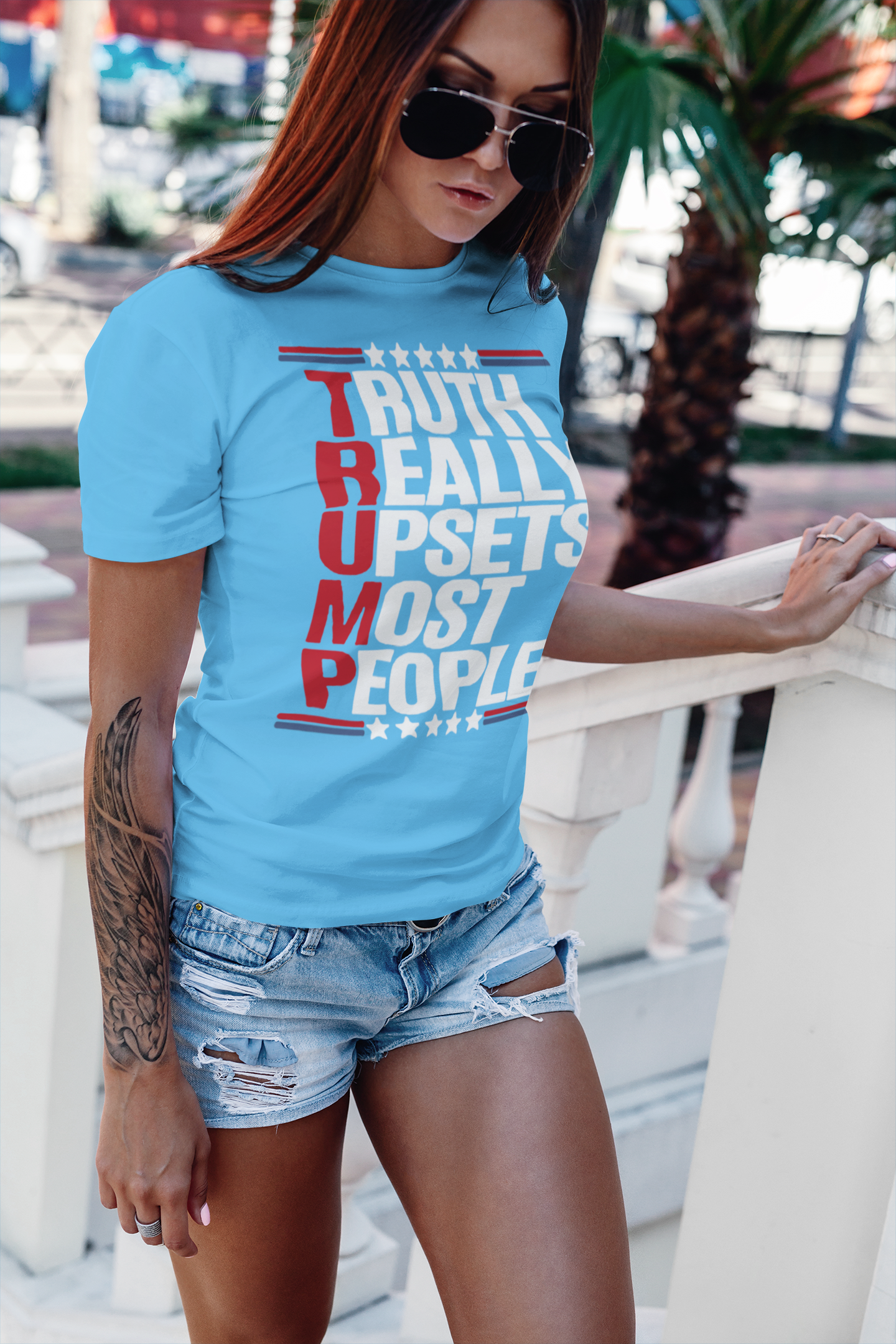 Model wearing a blue shirt with the text 'Truth Really Upsets Most People' in a vibrant design.