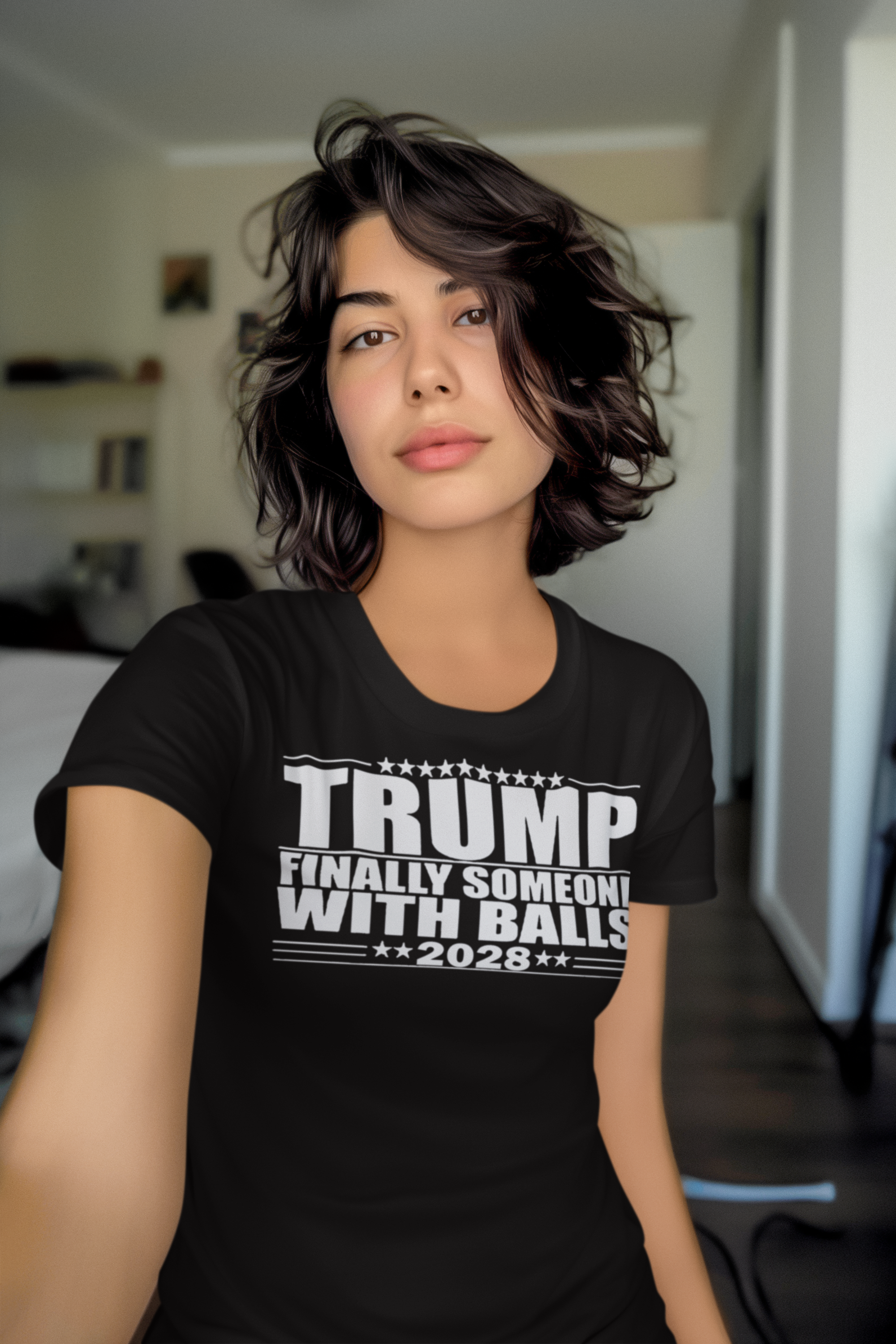 Woman wearing a black t-shirt with the text Trump 2028 Finally Someone With Balls, promoting conservative values.