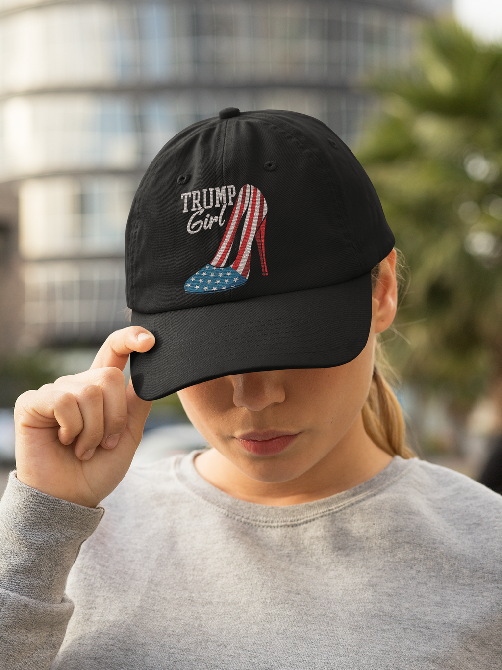 A woman wearing a Foam Trump Girl Trucker Cap Gear featuring a stylish design with red, white, and blue elements.
