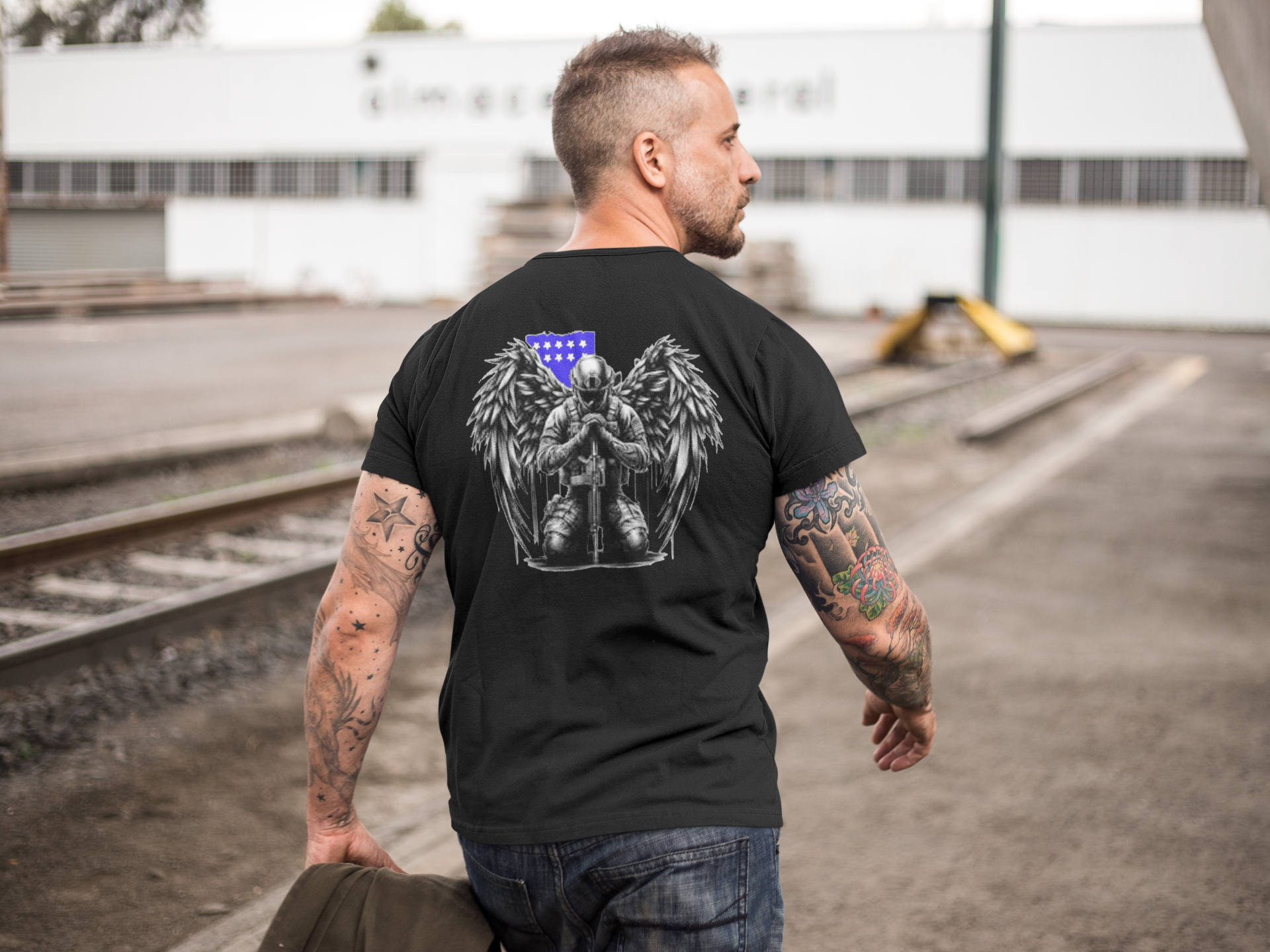 Man wearing Veteran With Wings Back Art Tee with winged design and American flag.