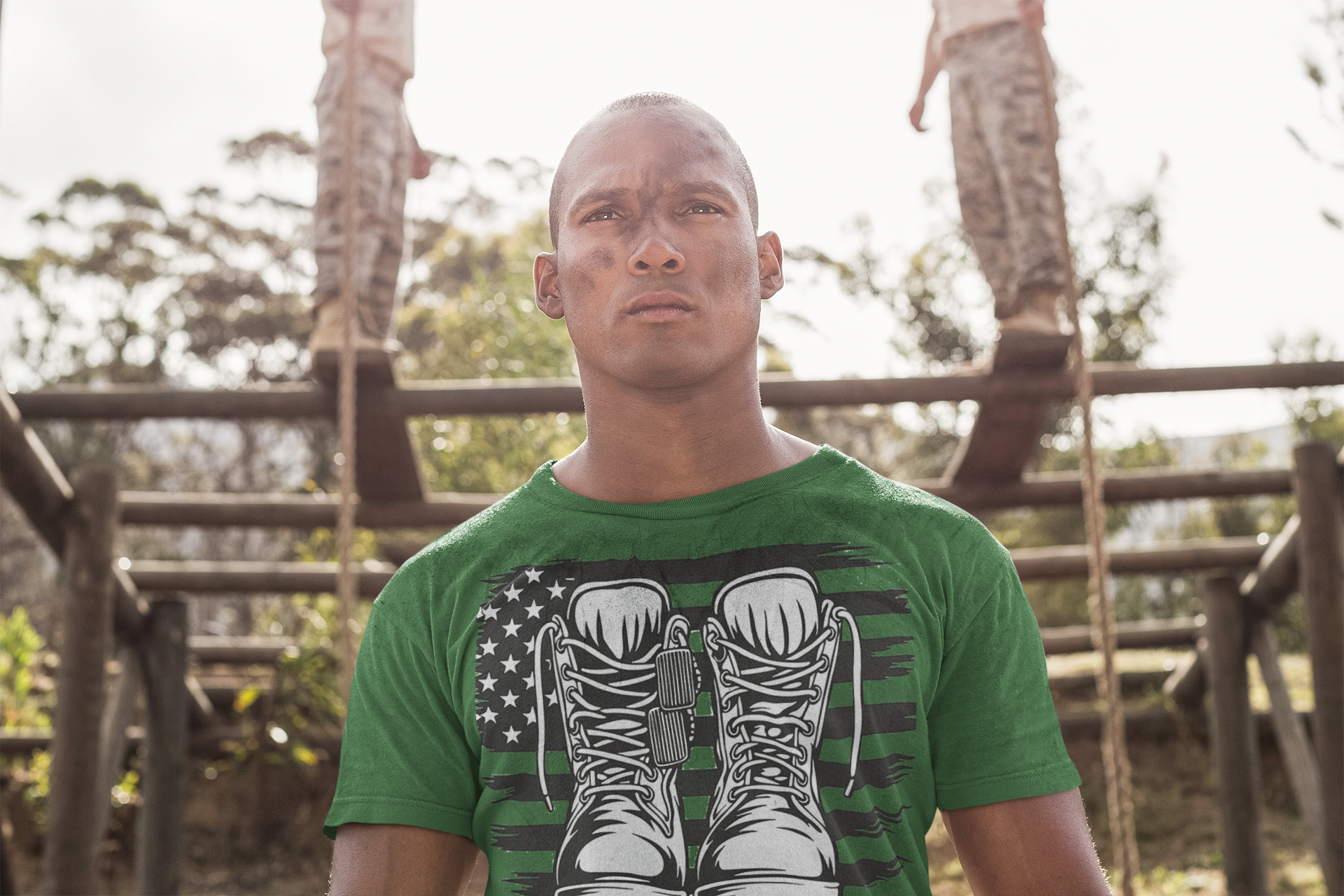 Man wearing Walk A Mile In Mine Apparel Art shirt with military boots design, outdoors, showing support for national ideals.