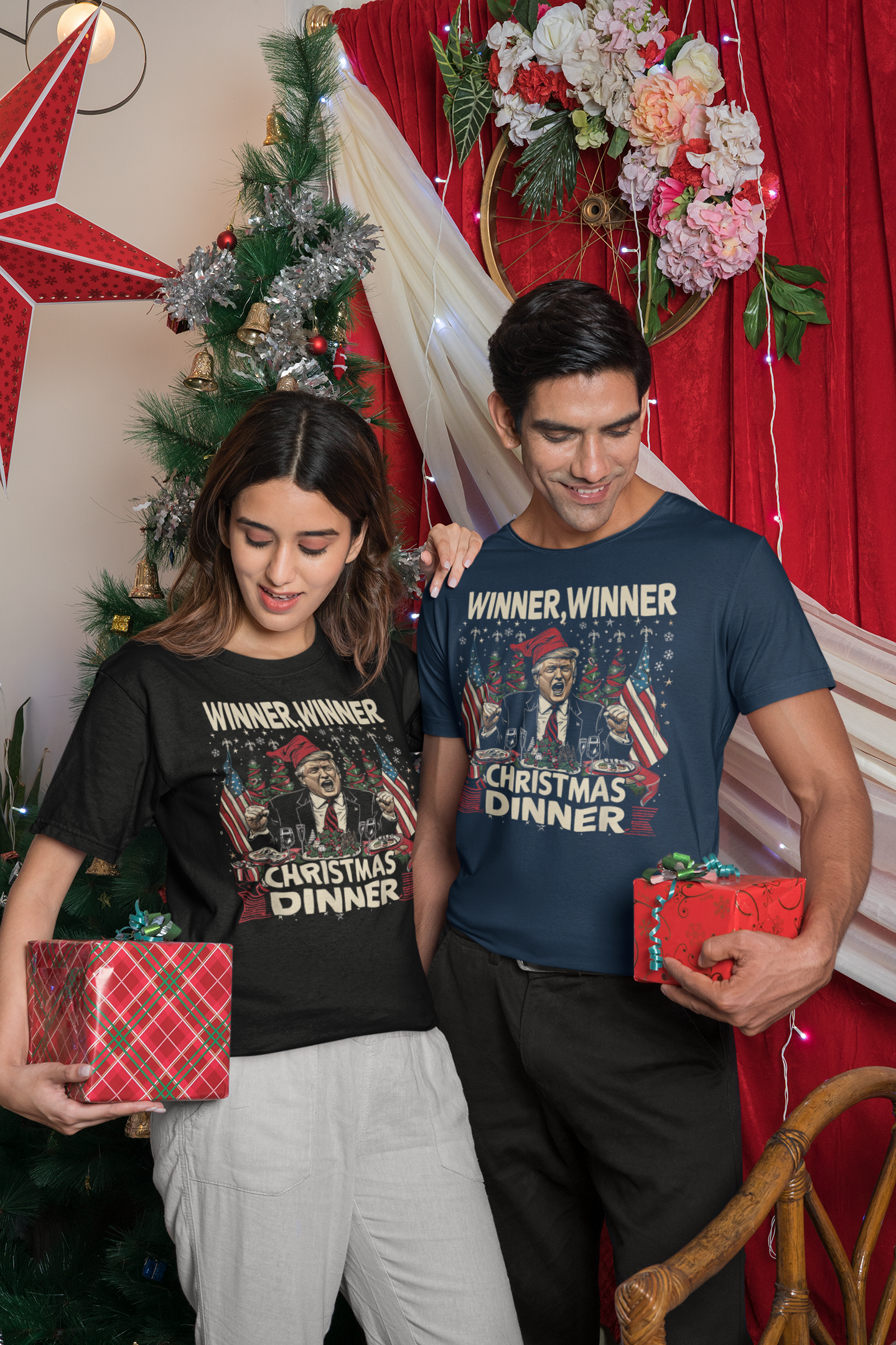 Couple wearing Winner Winner Christmas Dinner graphic t-shirts while holding gifts in a festive setting.