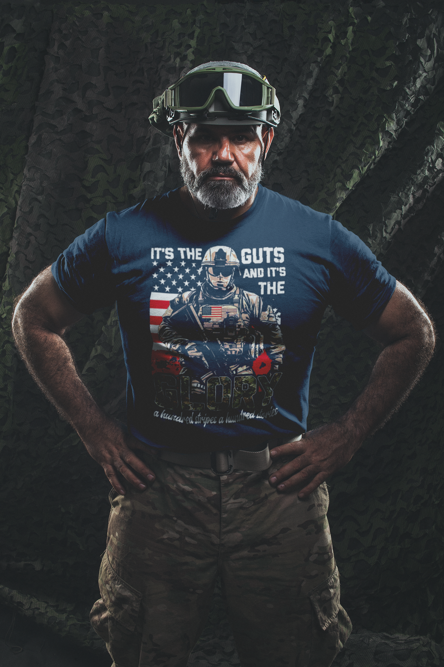 Man wearing military-style t-shirt with the phrase "It's The Guts And It's The Glory" against a camouflage background.