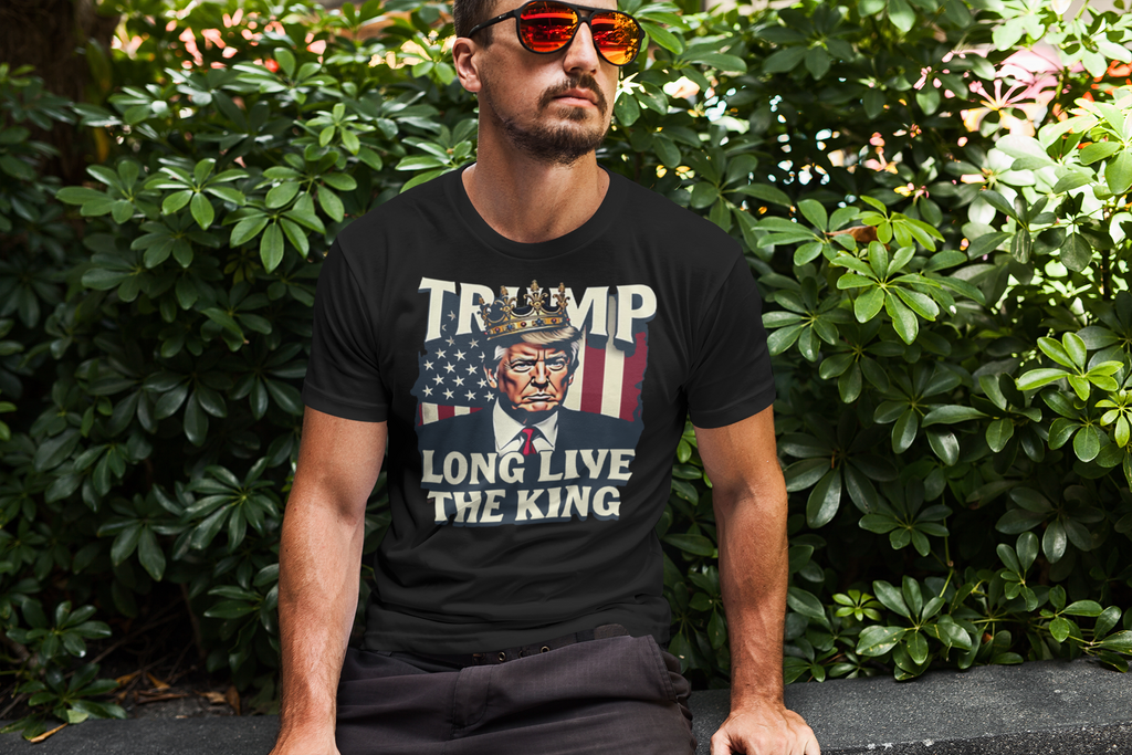 Man wearing Trump Long Live the King USA Shirt in a green leafy setting, showcasing bold political messaging.