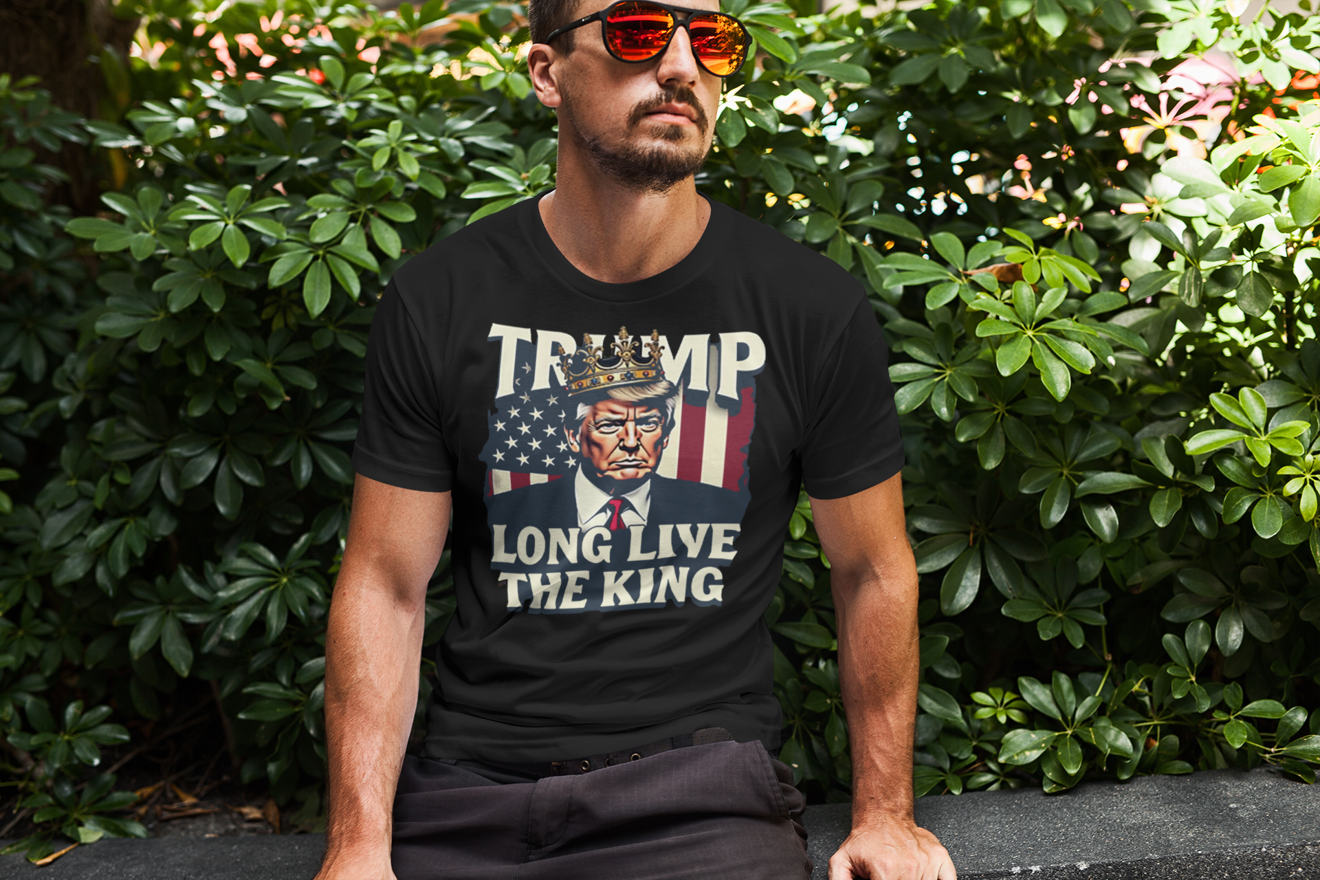Man wearing Trump Long Live the King USA Shirt in a green leafy setting, showcasing bold political messaging.