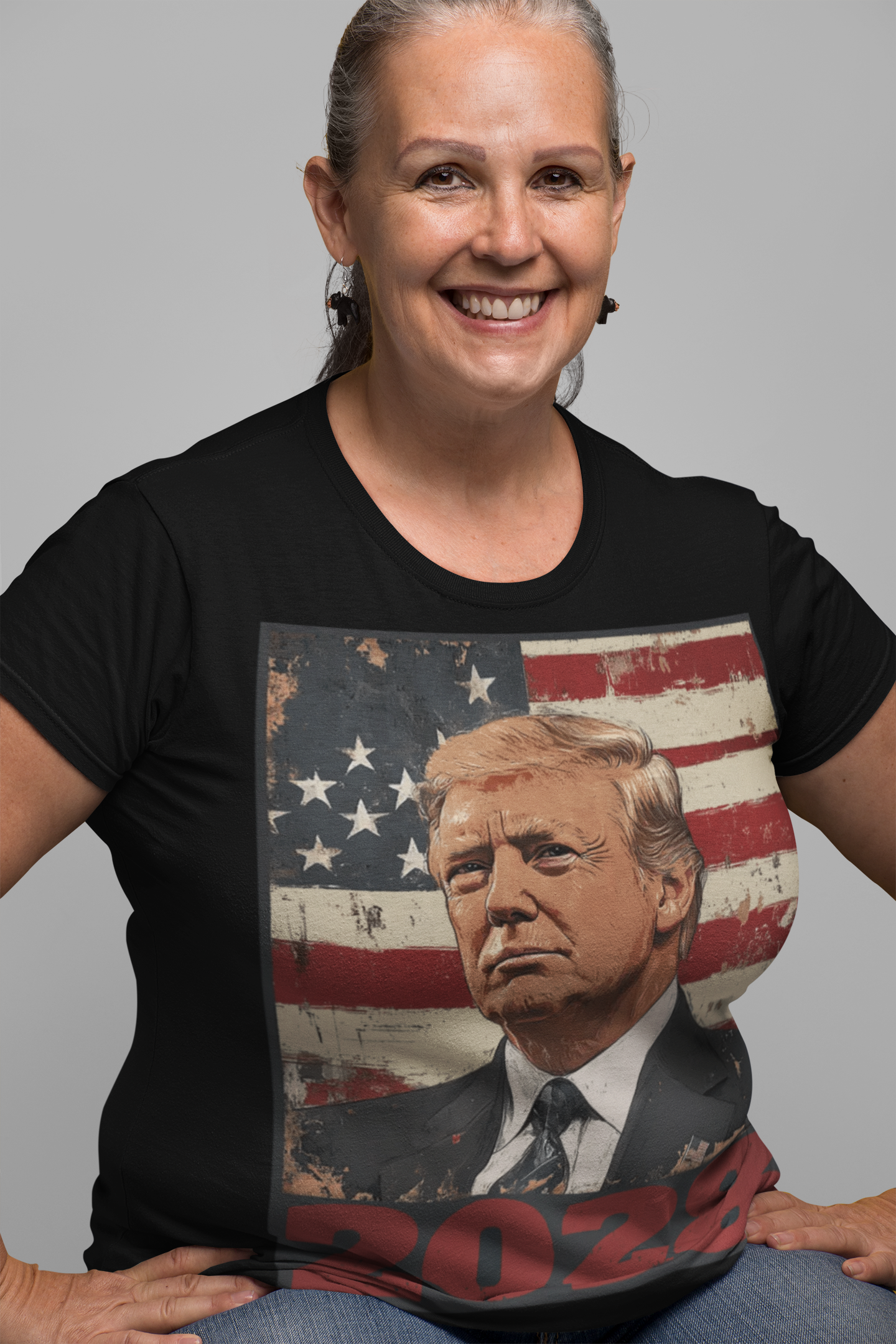 Woman wearing Trump 2028 USA Flag Motif Gear t-shirt with patriotic design and American flag background.