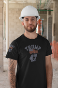 Man wearing a Trump 47 Patriotic Banner Print shirt and hard hat at a construction site.