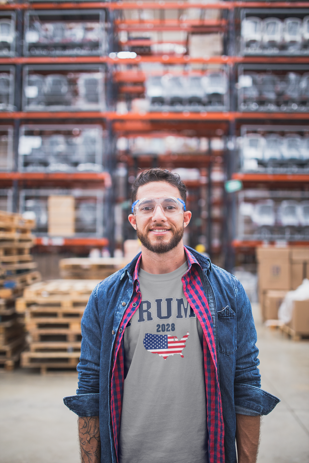 USA Flag Trump 2028 Campaign Art graphic tee worn by man in warehouse with shelves in background.