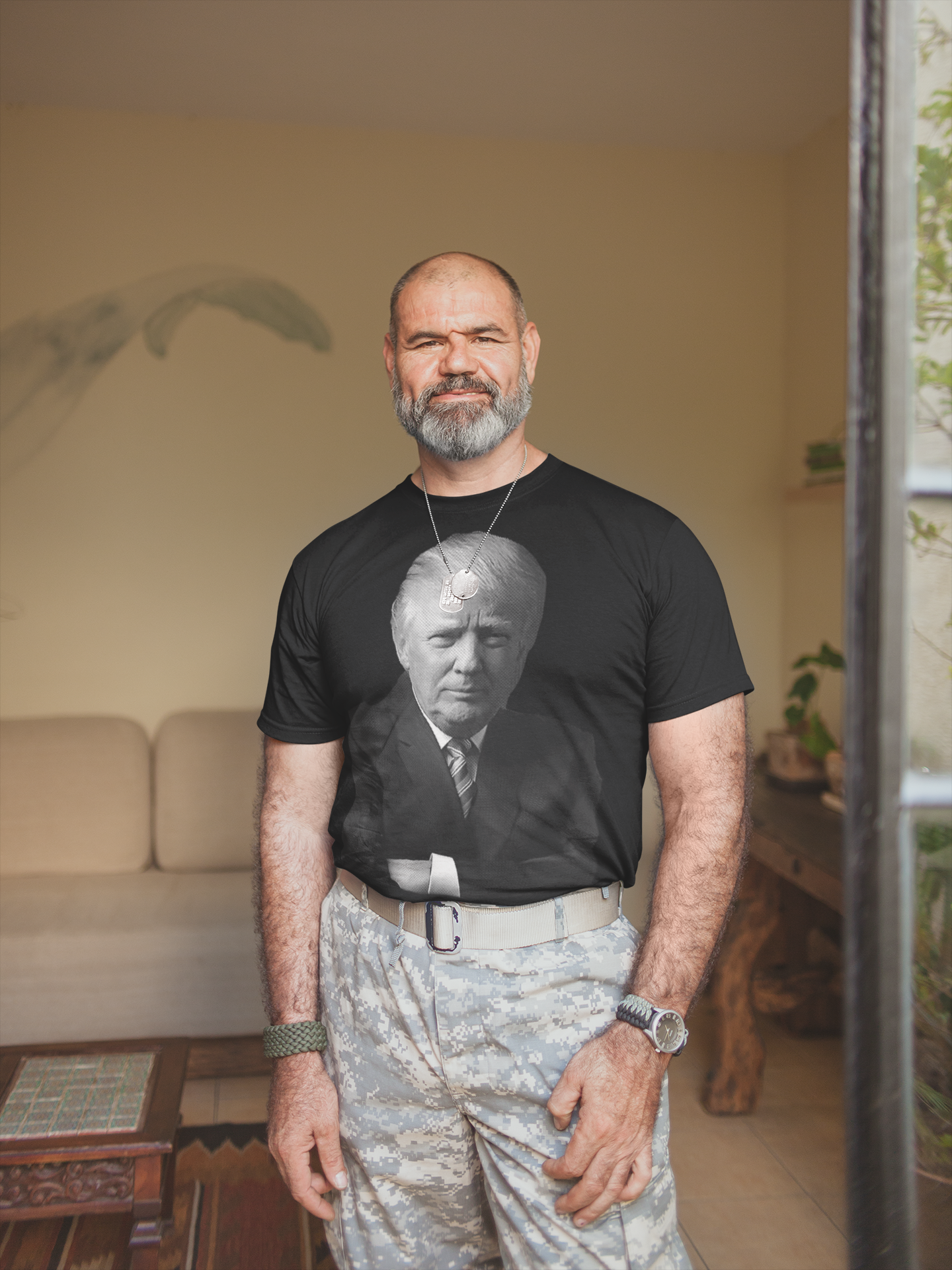 Man wearing Trump Confident Crossed Arms Art graphic tee in a relaxed indoor setting.