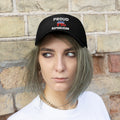 Classic Proud Republican Twill Baseball Cap worn by a model with expressive hair against a brick wall.