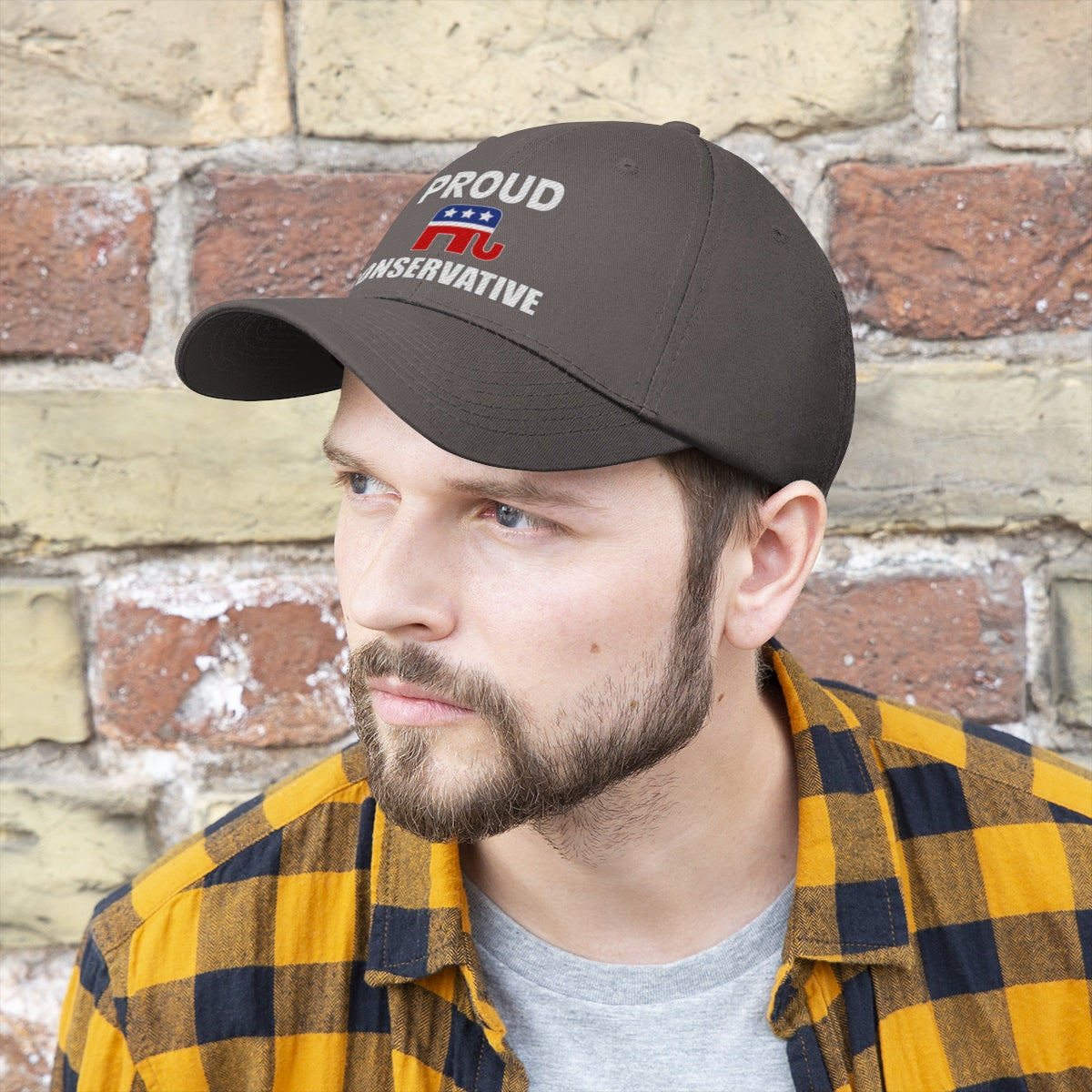 Classic Proud Conservative Twill Baseball Cap worn by a man with a beard against a brick wall.