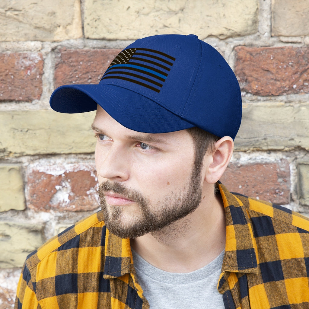 Thin Blue Line American Flag Twill Cap worn by a man against a brick wall, representing support for law enforcement.