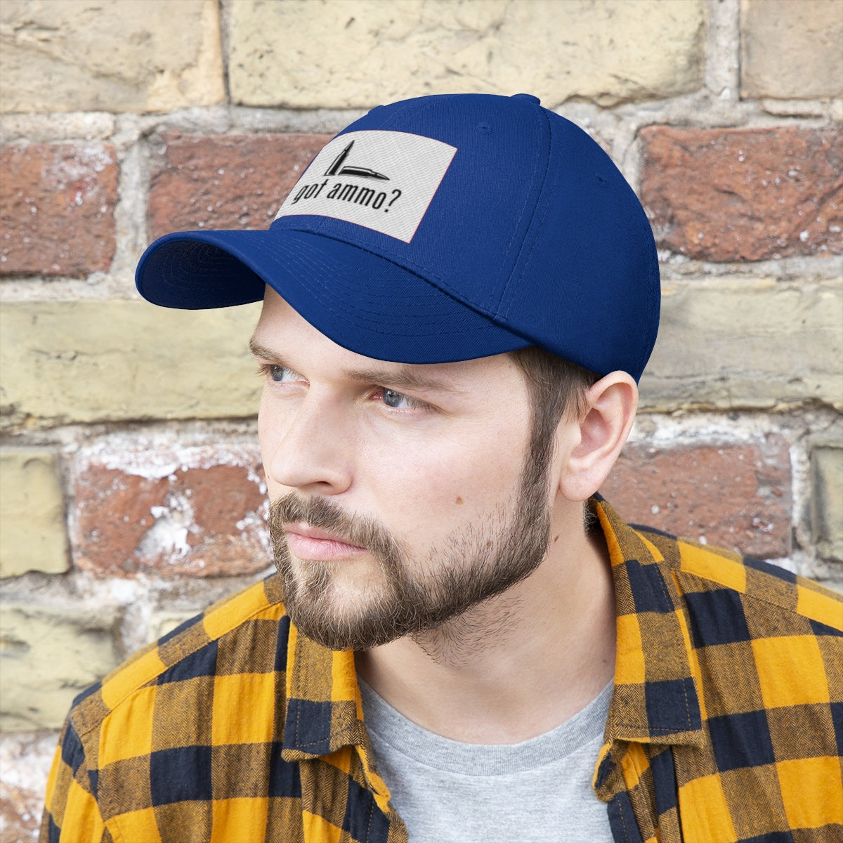 Got Ammo Twill Cap Funny Tactical Style Cap worn by a man with beard and brown plaid shirt, against a brick wall backdrop.