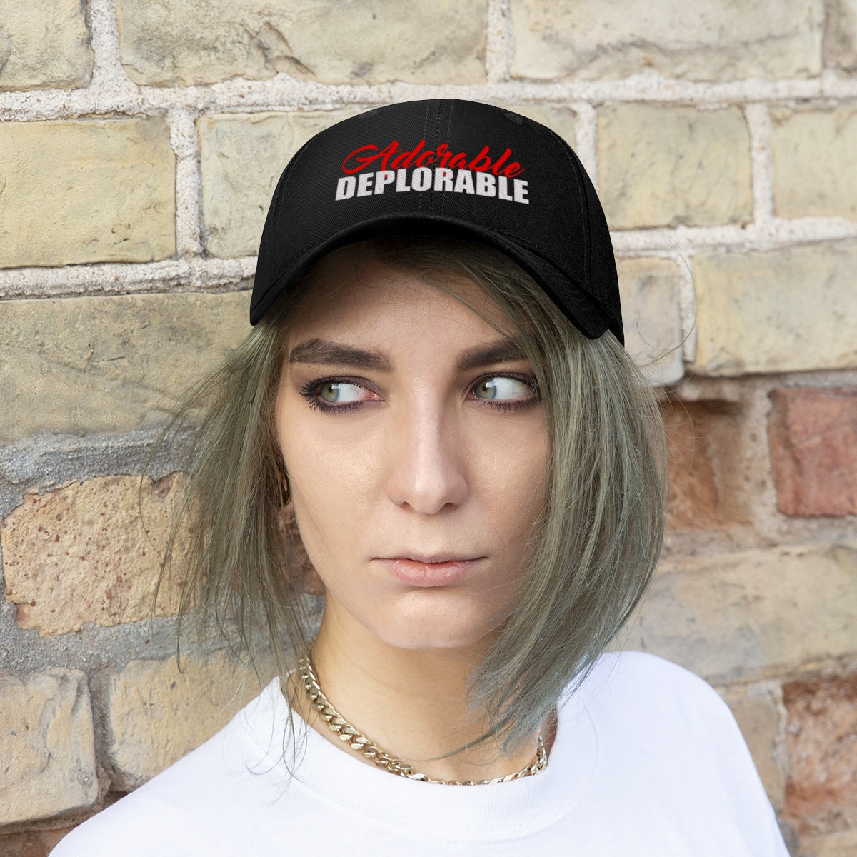Adorable Deplorable Embroidered Twill Cap worn by a model with casual attire against a brick background.