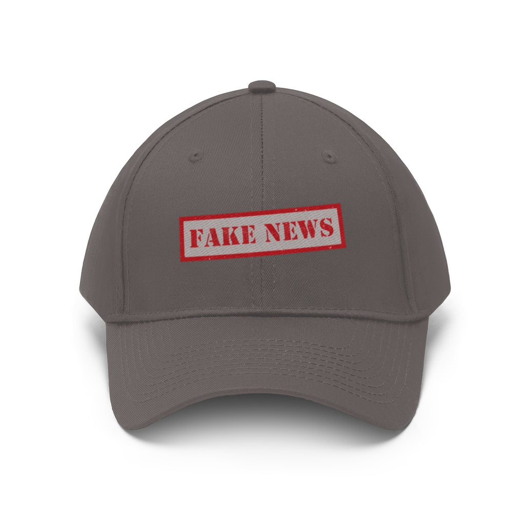 Fake News Twill Cap Bold Humor Casual Wear Hat in gray with red lettering.