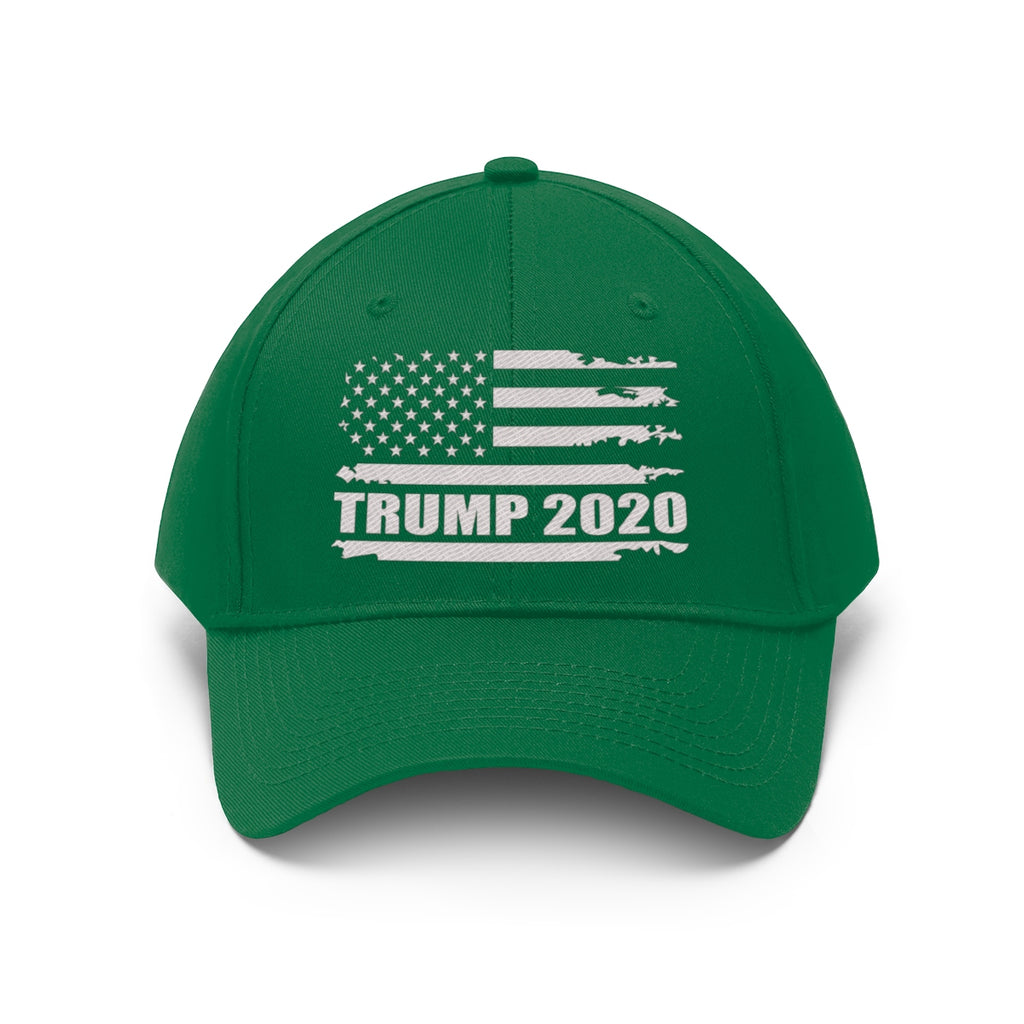 Trump 2020 Distressed American Flag Wht Ltrs Twill Cap on a green baseball cap.