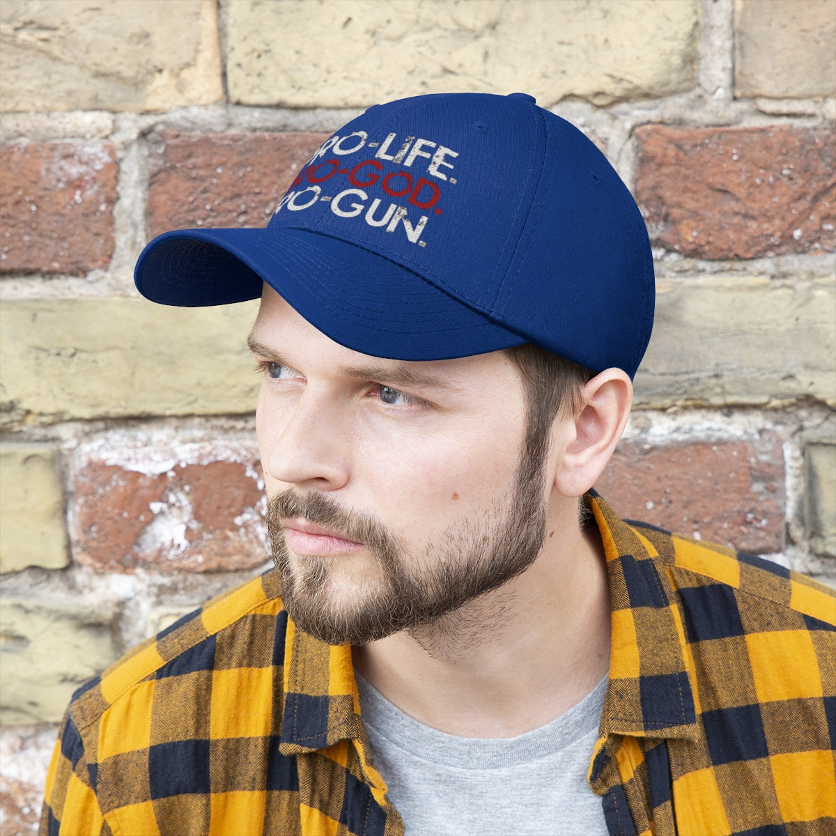 Pro-Life Pro-God Pro-Gun Cotton Twill Cap worn by a man against a textured wall.