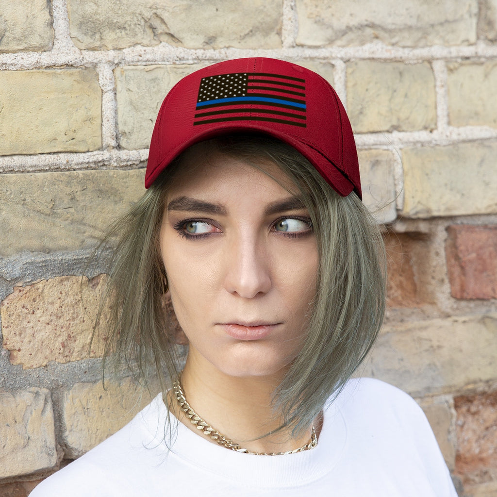 Thin Blue Line American Flag Twill Cap worn by a model against a brick wall backdrop.