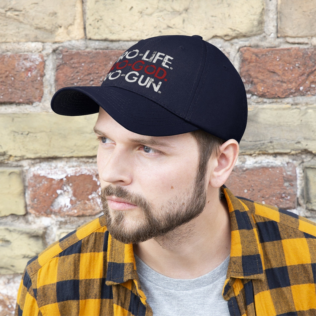 Pro-Life Pro-God Pro-Gun Cotton Twill Cap worn by a man with a beard, against a brick wall background.