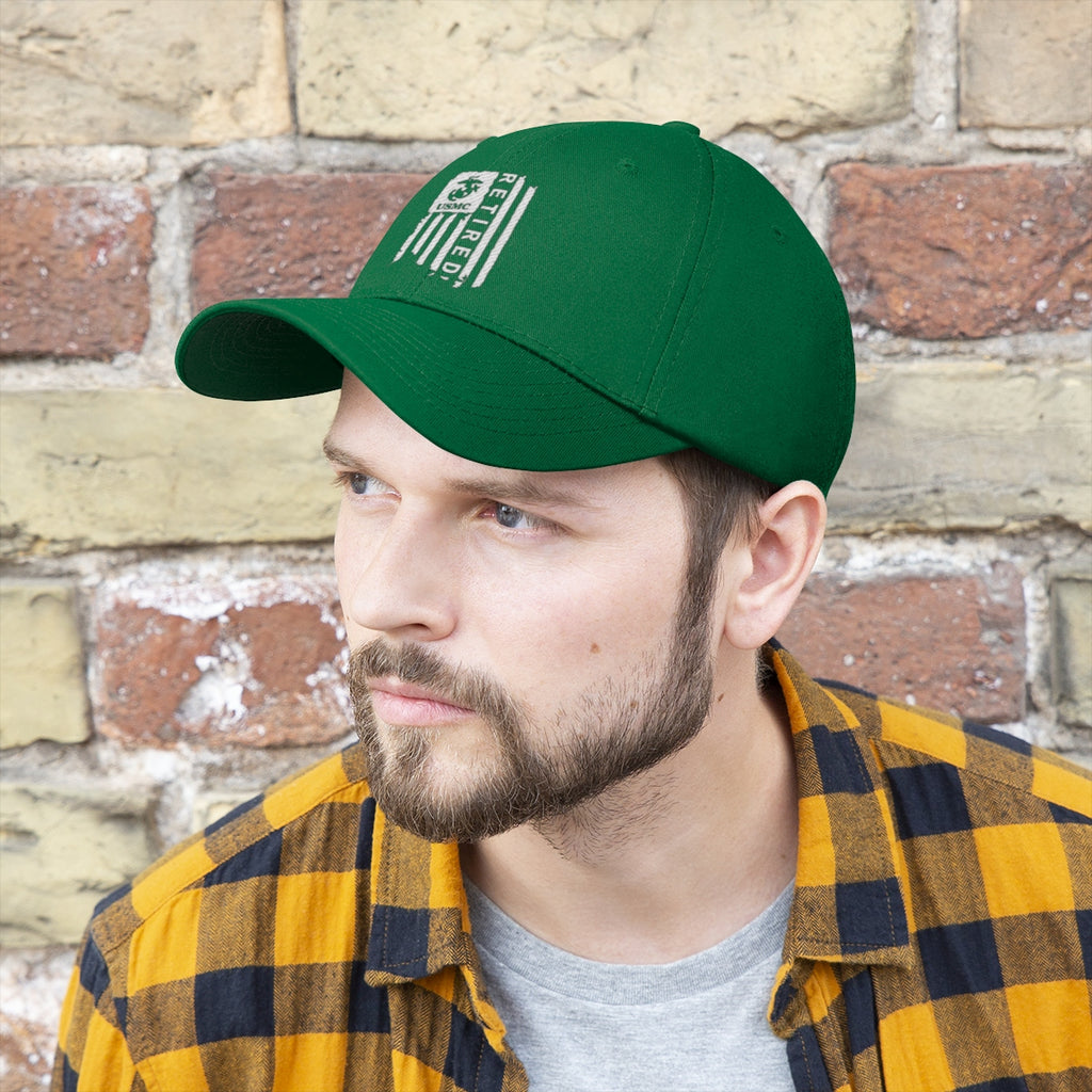 USMC Retired On Distressed American Flag Twill Cap worn by a man with a plaid shirt against a brick wall.