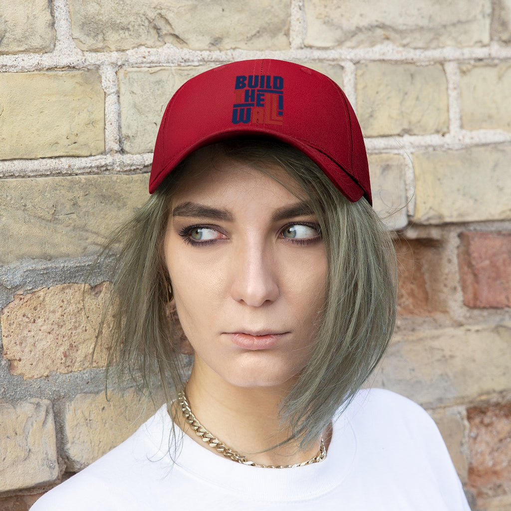 Build The Wall Twill Cap Classic Statement Wear Cap worn by a model against a brick backdrop.