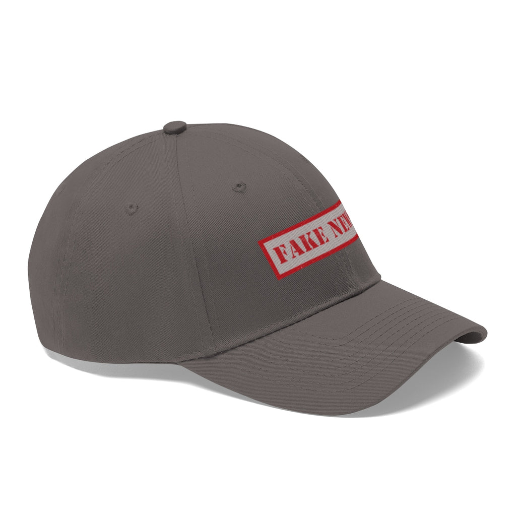 Fake News Twill Cap Bold Humor Casual Wear Hat in gray with red lettering, perfect for casual outfits and playful commentary.