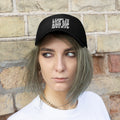 I Came To Kick Ass And Dip And I'm All Out Of Dip Twill Cap worn by a model against a brick wall.