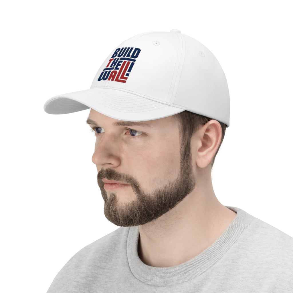 Build The Wall Twill Cap Classic Statement Wear Cap worn by a man, showcasing its bold design and style.