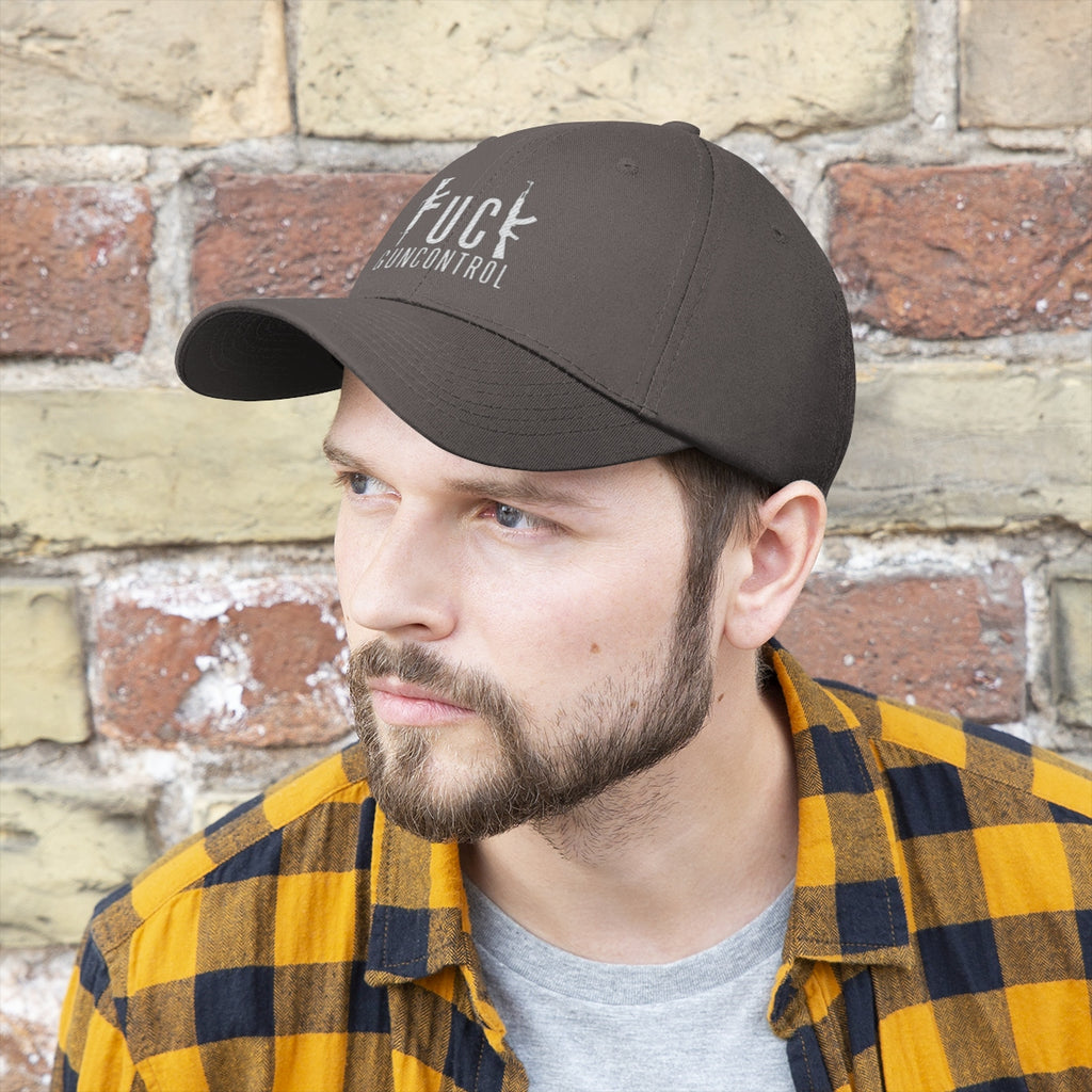 Man wearing a Vintage Fuck Gun Control Cotton Twill Cap against a brick wall, showcasing the stylish design and fit.