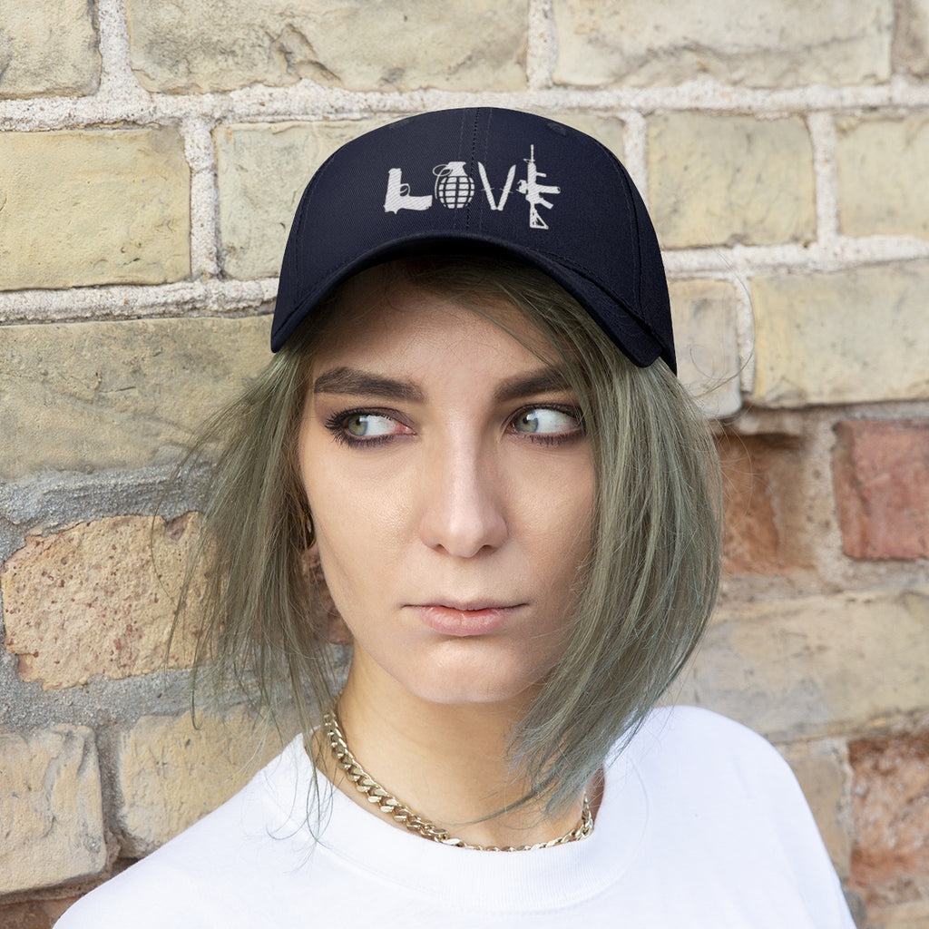 Model wearing Love Combat Inspired Street Style Twill Cap against a brick wall, showcasing its bold design.